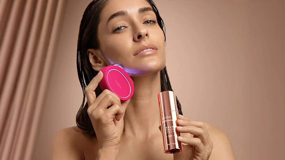 A woman using BEAR 2 microcurrent skin tightening device on jawline